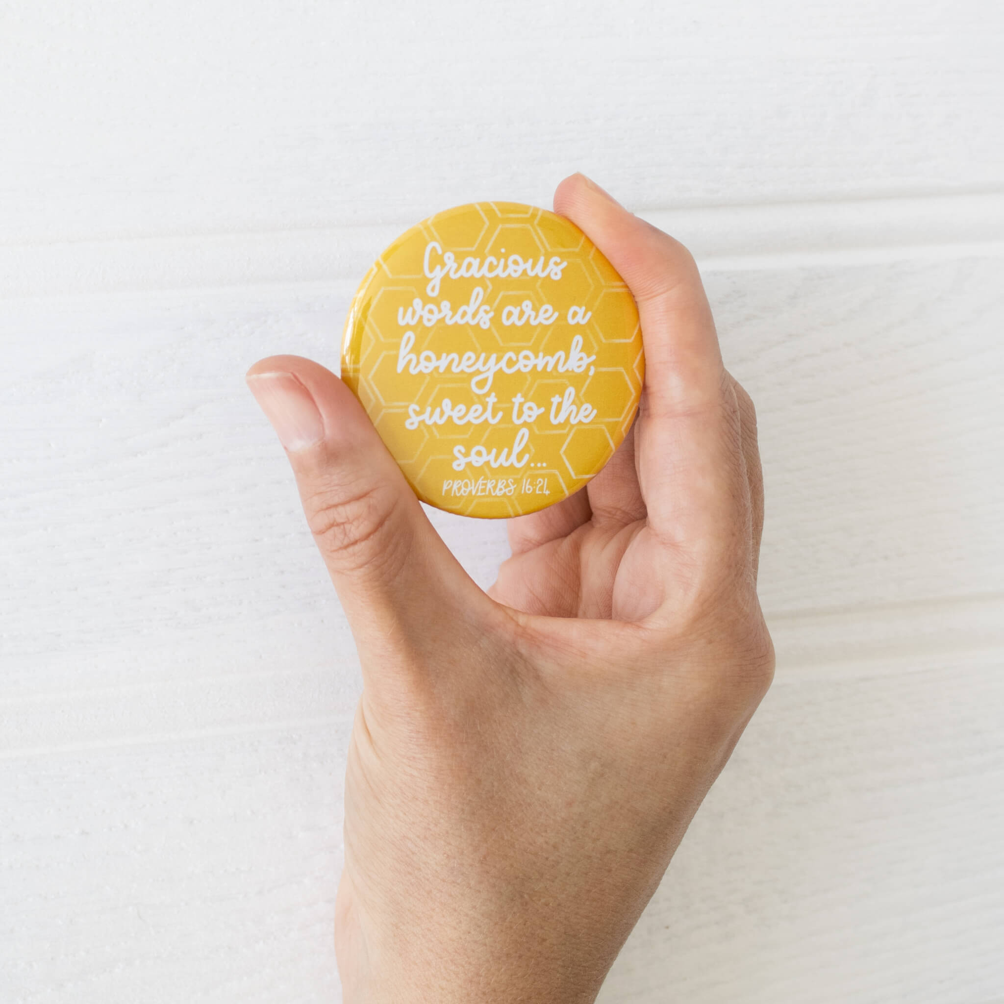 Gracious Words are a Honeycomb Pocket Mirror held in hand to show size