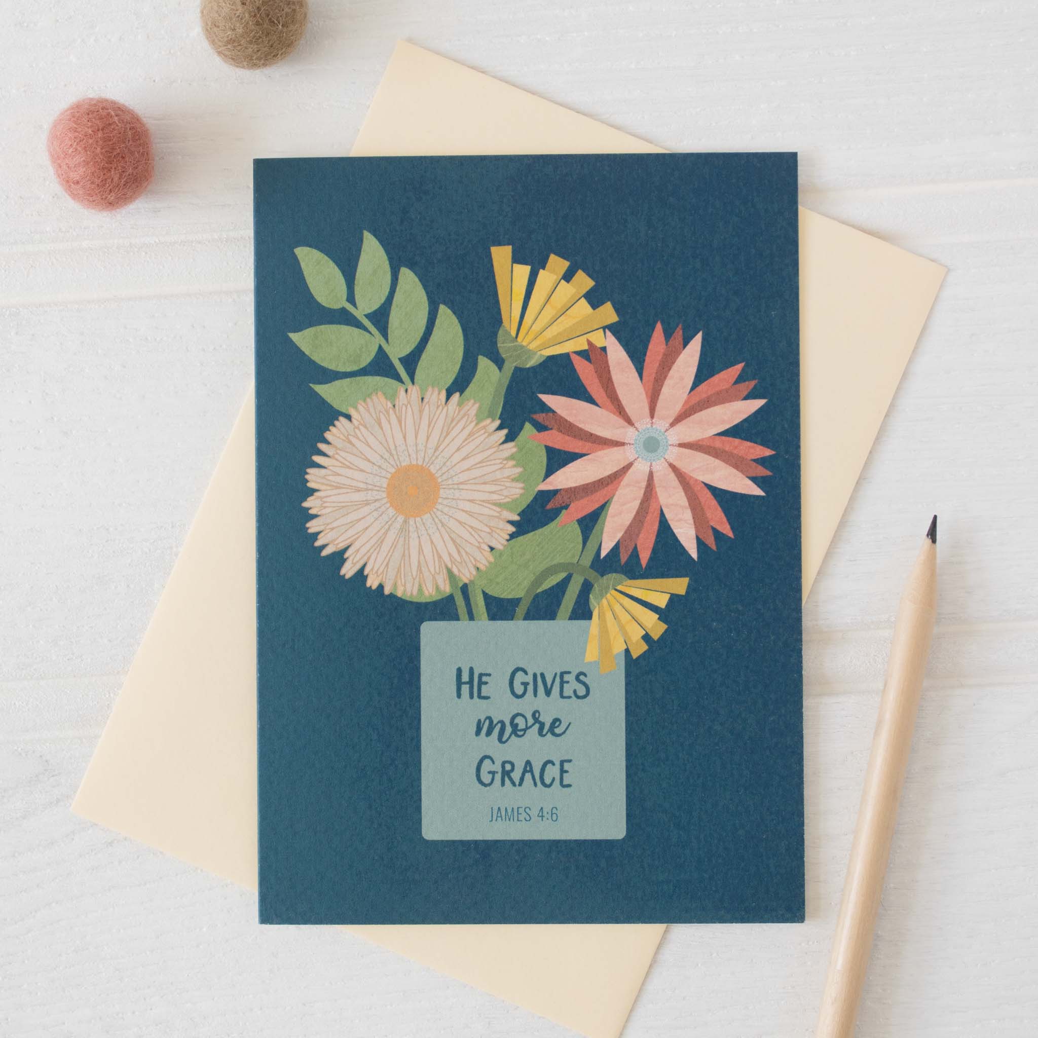 He Gives More Grace Card with blue background and envelope